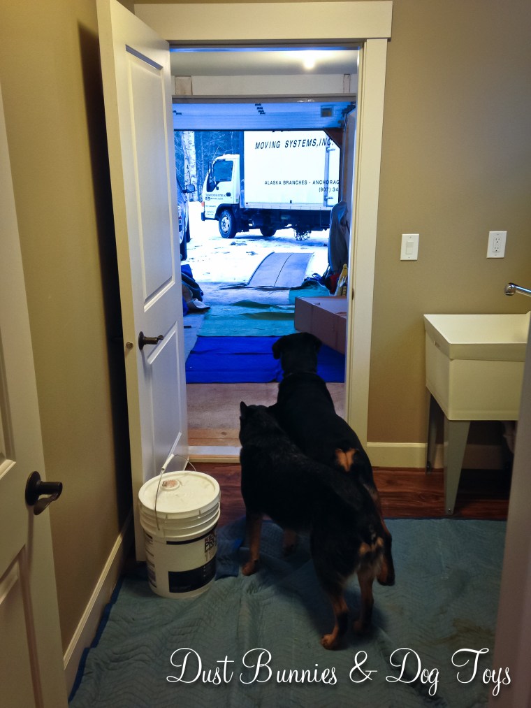 The girls watch as the moving truck pulls into position.
